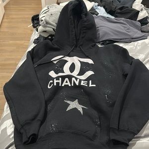 Black hoodie with sequin star on the pocket